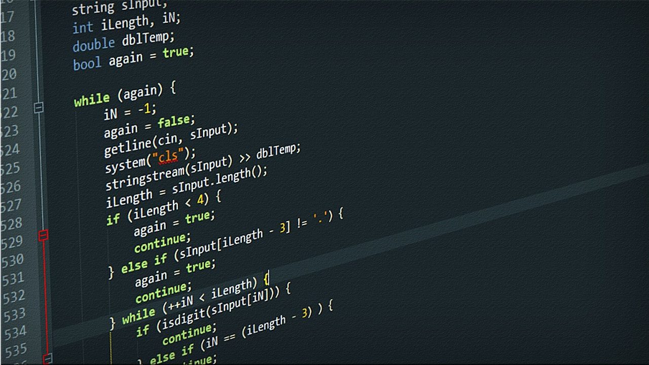 A programmer's monitor displaying colorful lines of open-source code in a dark-themed editor.
