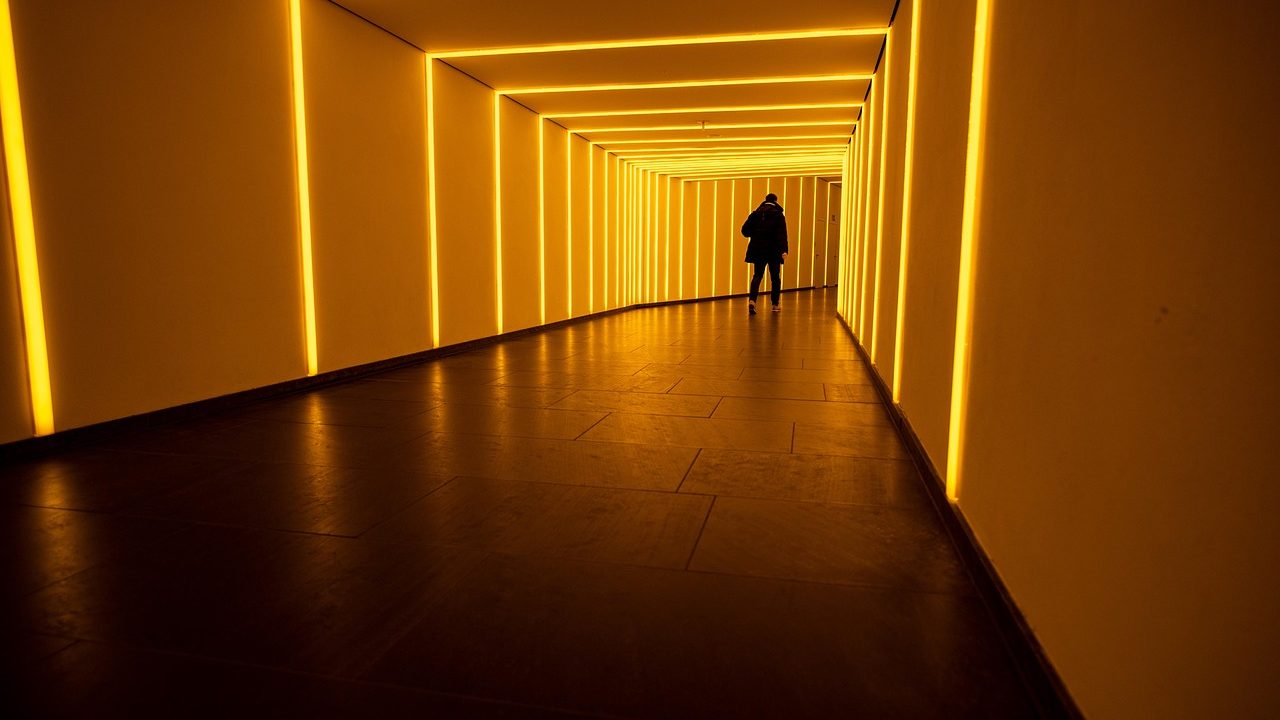 A long illuminated tunnel inside an underground scientific research facility.
