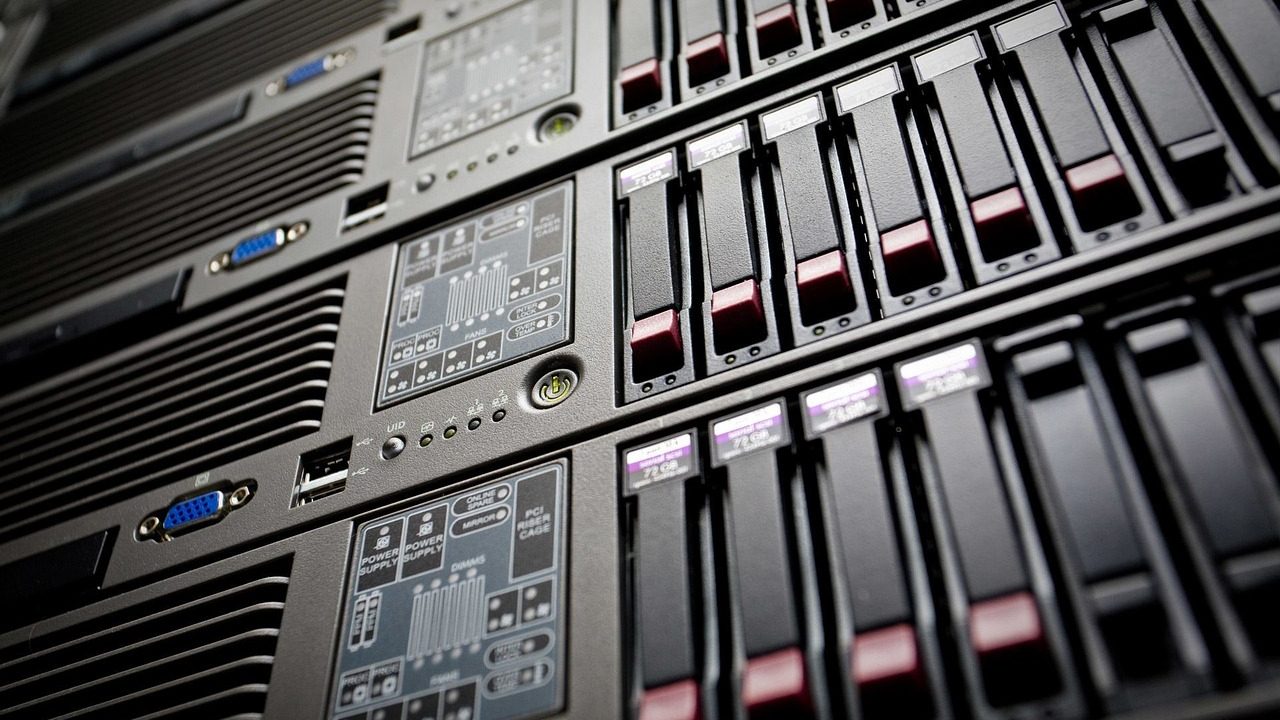 Rows of illuminated server racks inside a data center corridor.