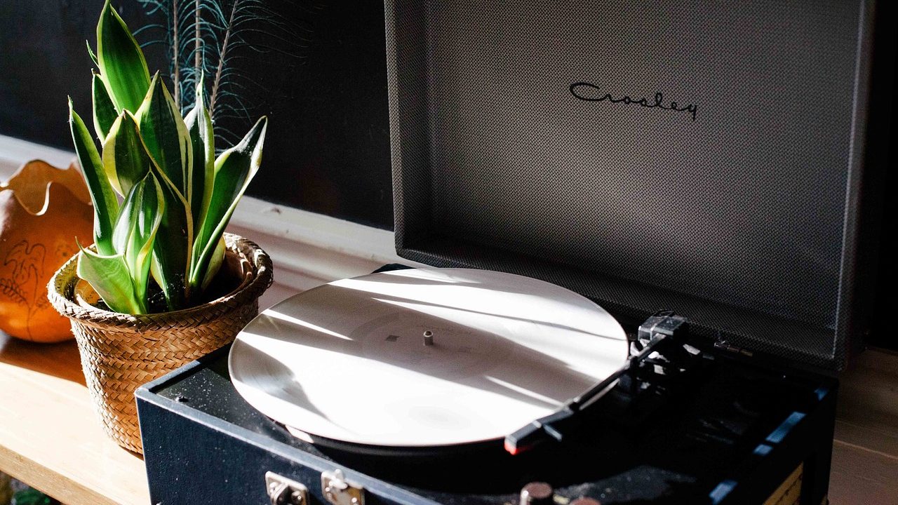 A classic white portable digital music player resting on a wooden surface.