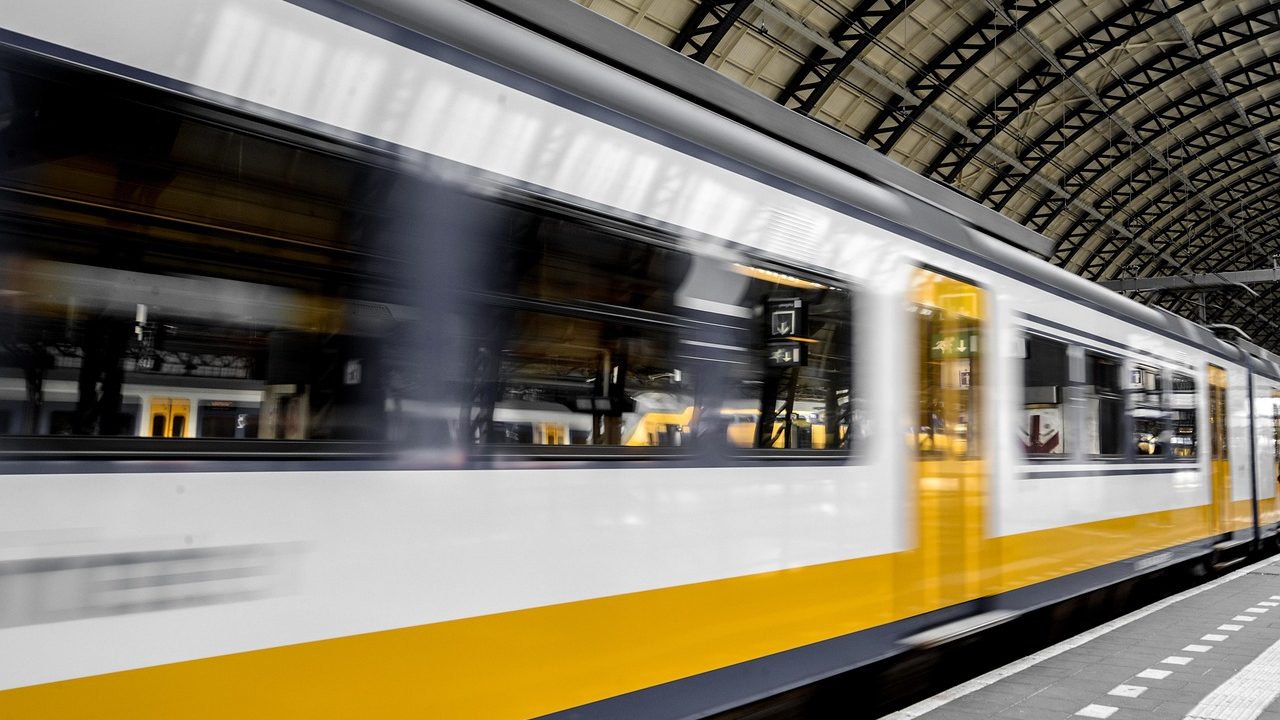 An empty railway platform with train tracks extending into the distance.