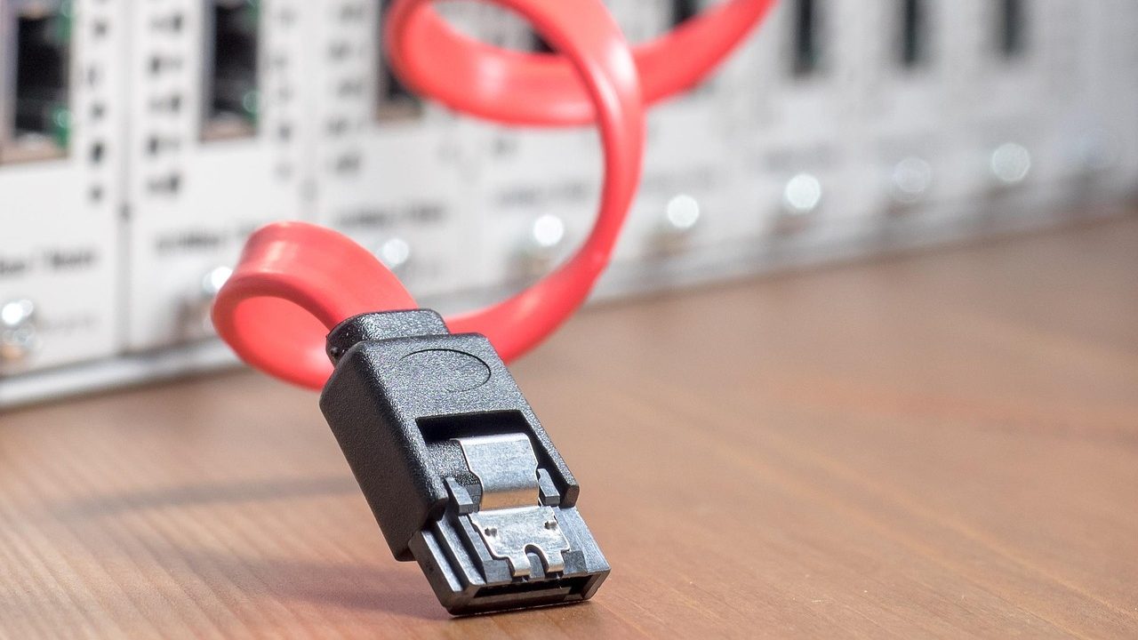 Dense network cables connected to a rack-mounted database server in a data center.