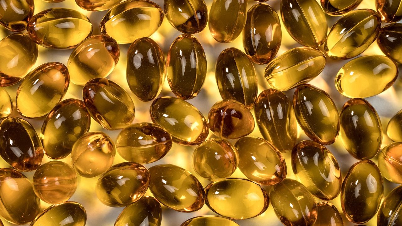 Close-up of prescription pills and capsules arranged on a surface.