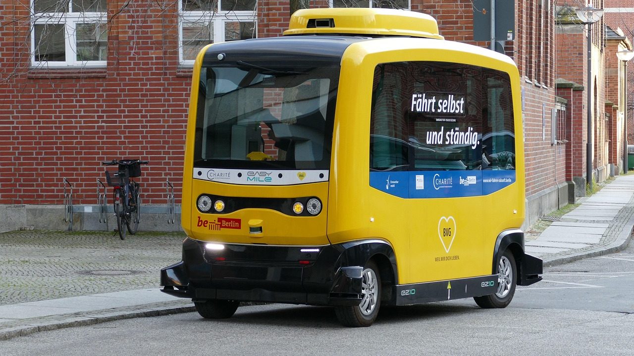 A self-driving car roof mounted with lidar and sensor equipment on a city street.
