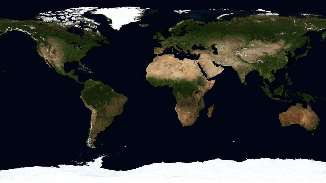 A illuminated world map showing major international shipping routes across oceans.