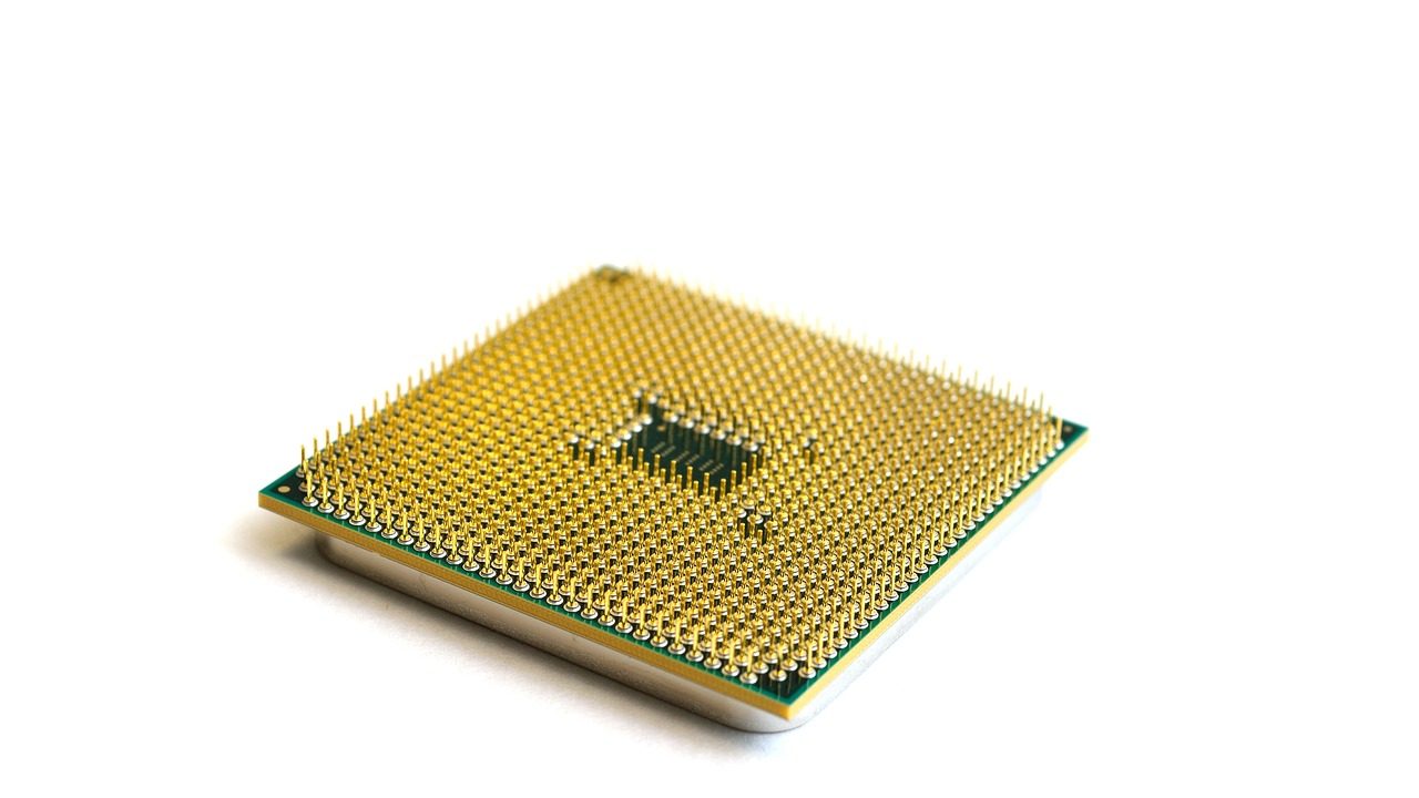 A macro photograph of a semiconductor microchip on a circuit board.