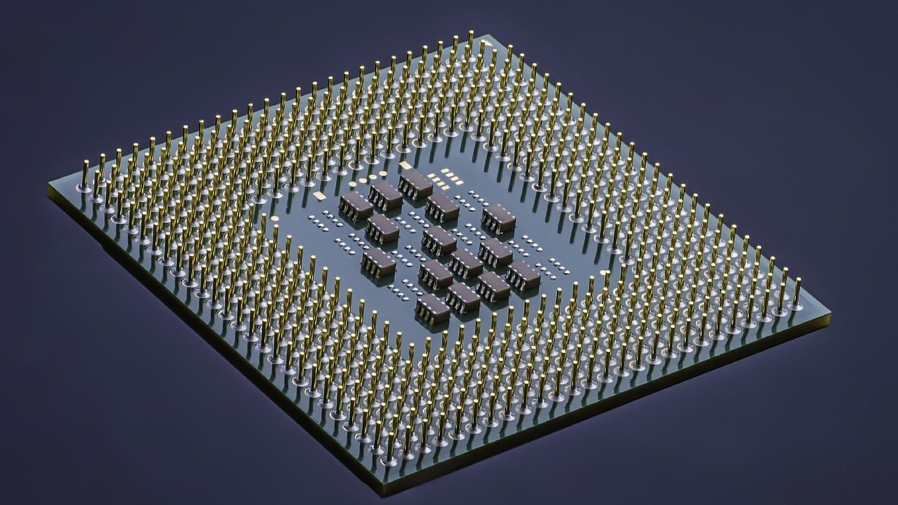A macro photograph of a semiconductor microchip on a circuit board.