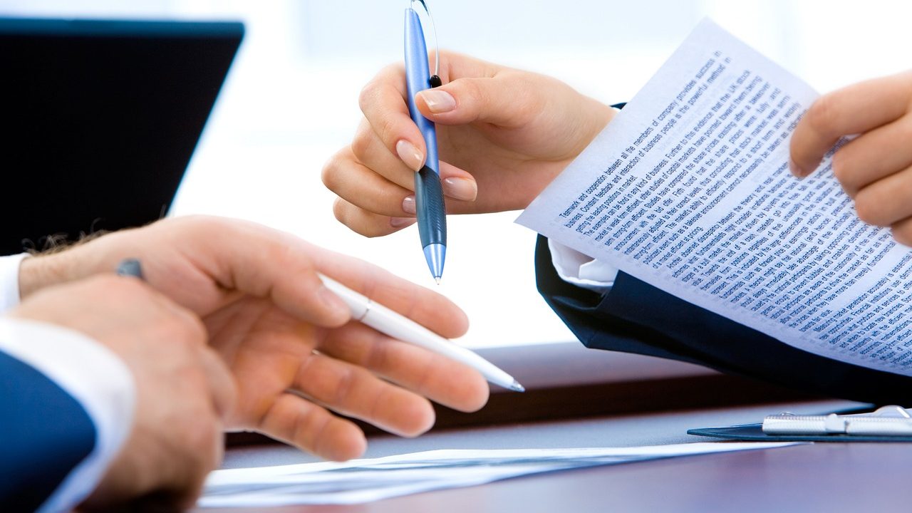 A desk with financial documents and a calculator suggesting loan paperwork.