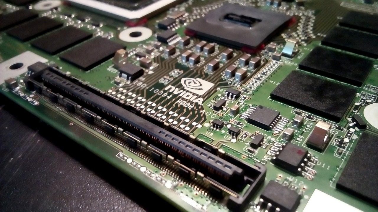 A close-up of a modern GPU circuit board with cooling fins and chips.