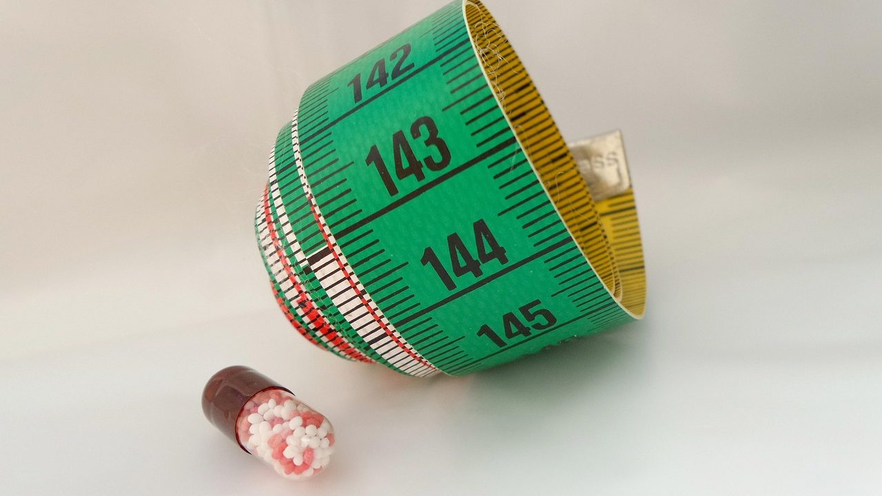 Close-up of prescription pills spilling from a medication bottle.
