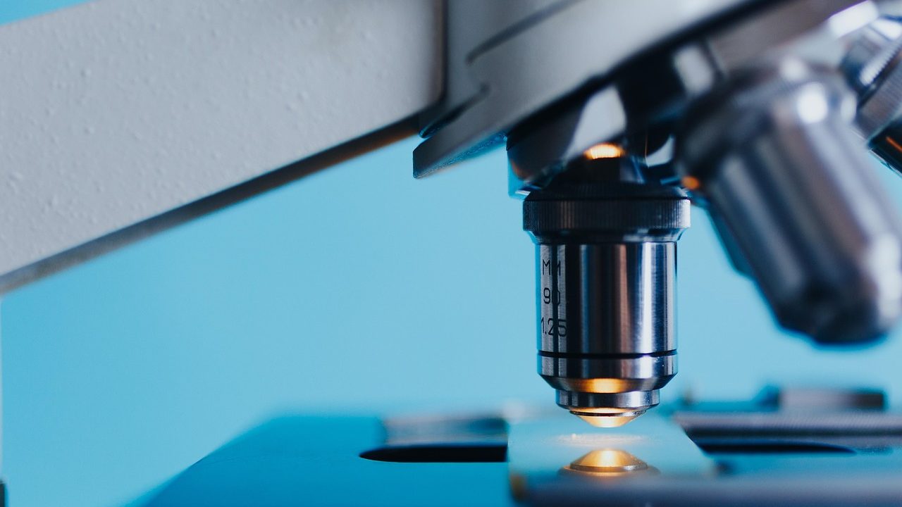 A laboratory workstation with glowing DNA sequencing equipment and sample vials.