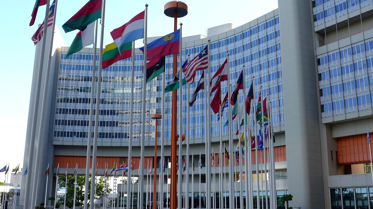 An empty formal negotiation table set for diplomatic talks.