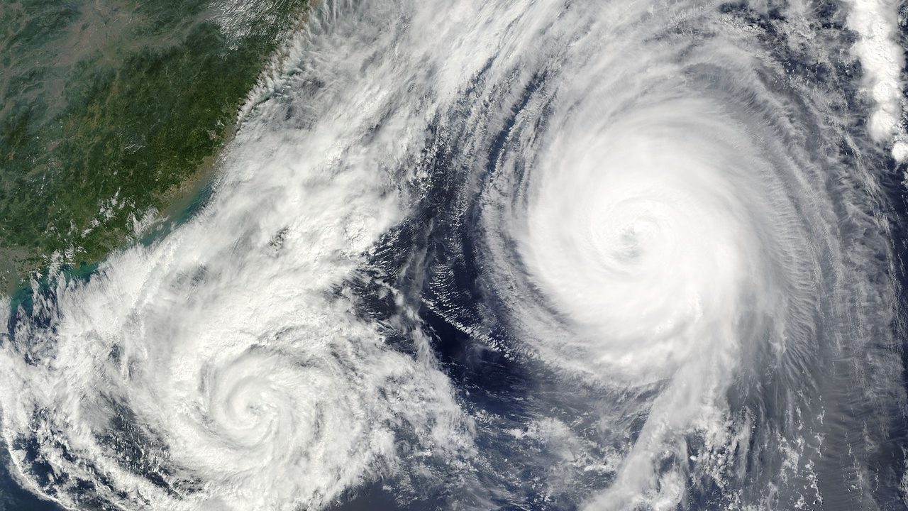 Satellite image of a large spiral tropical cyclone system over ocean water.