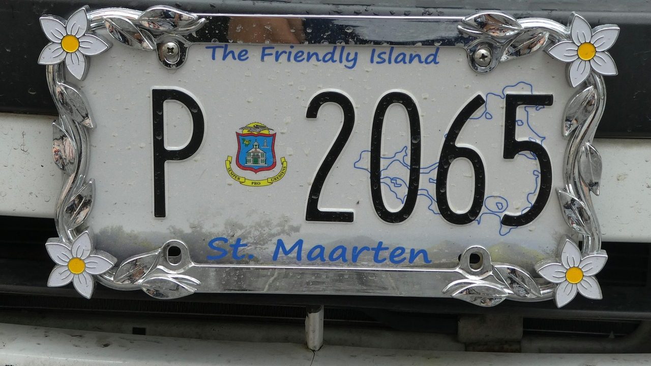 A mounted license plate reader camera positioned beside a roadway at dusk.