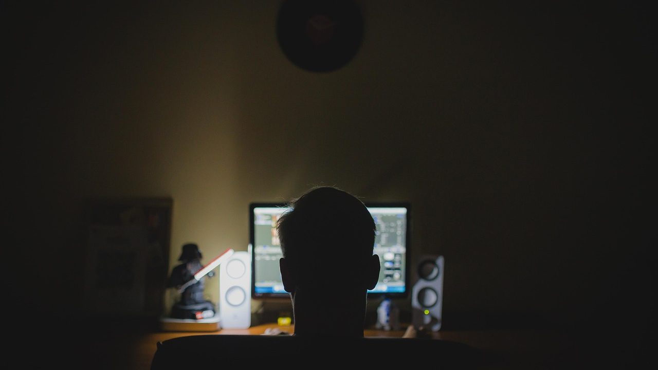 Green and white lines of programming code scrolling across a dark monitor screen.