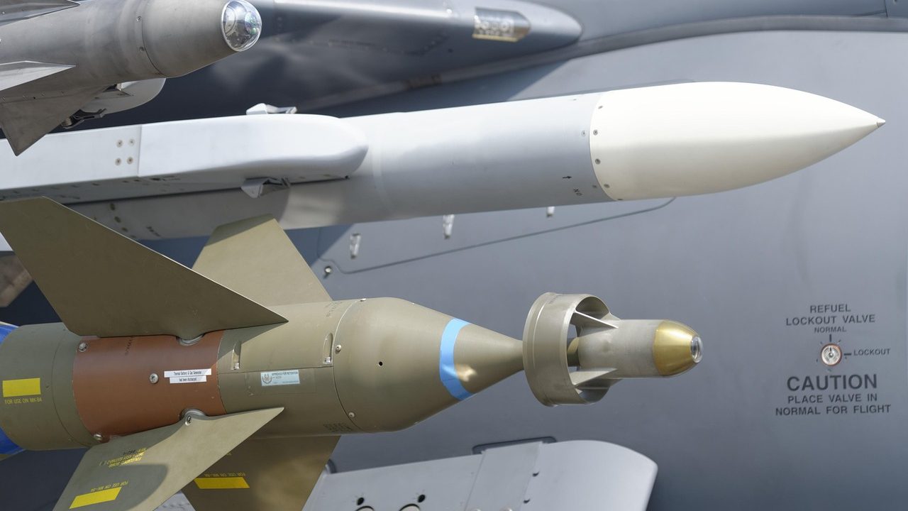 A military missile defense battery with a large radar dish set against a cloudy sky.