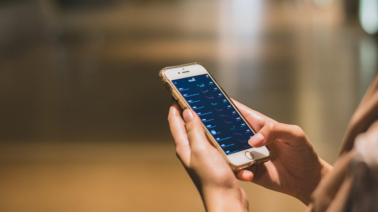 A close-up of a smartphone screen displaying a financial app interface with account balance and transfer options.