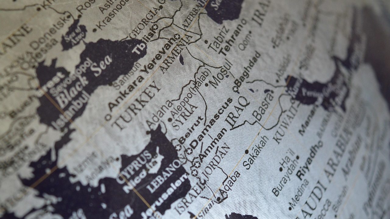 A backlit world map showing international borders and major regions.
