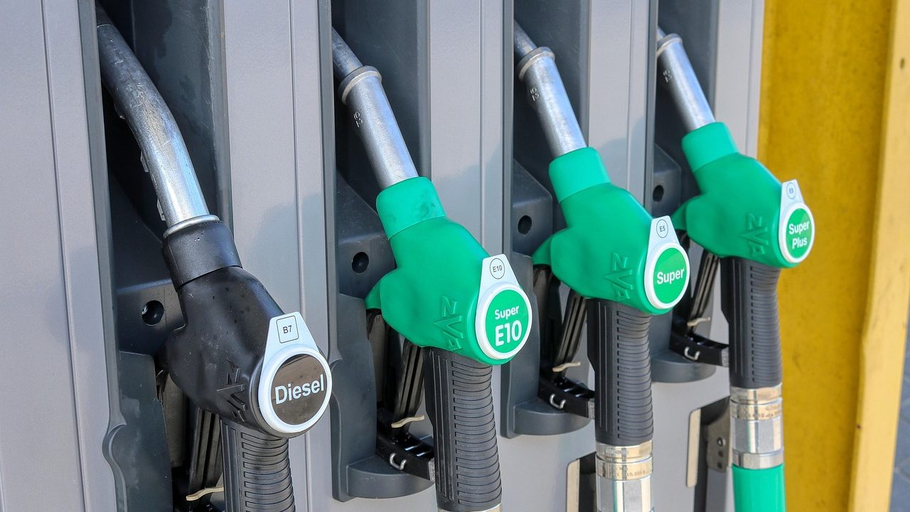 A large truck being refueled at a commercial diesel pump at a highway truck stop.