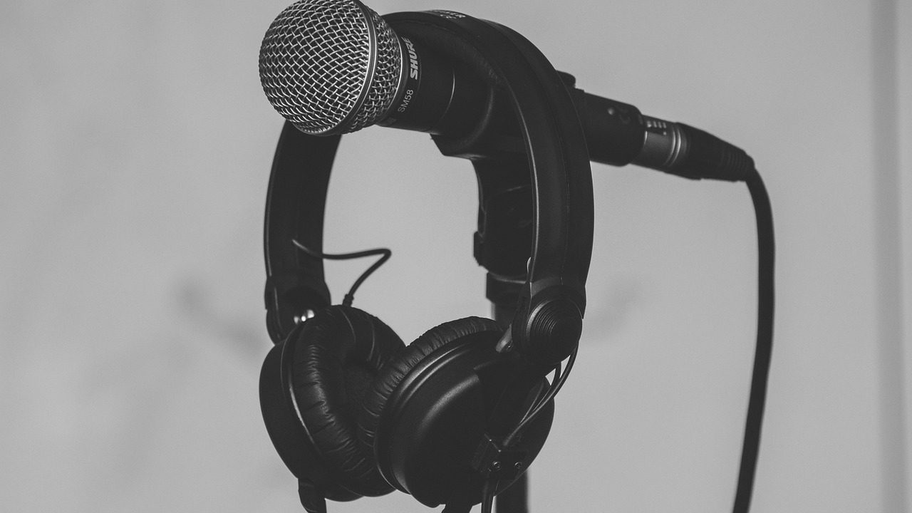 A microphone on a wooden witness table in a formal government hearing room.
