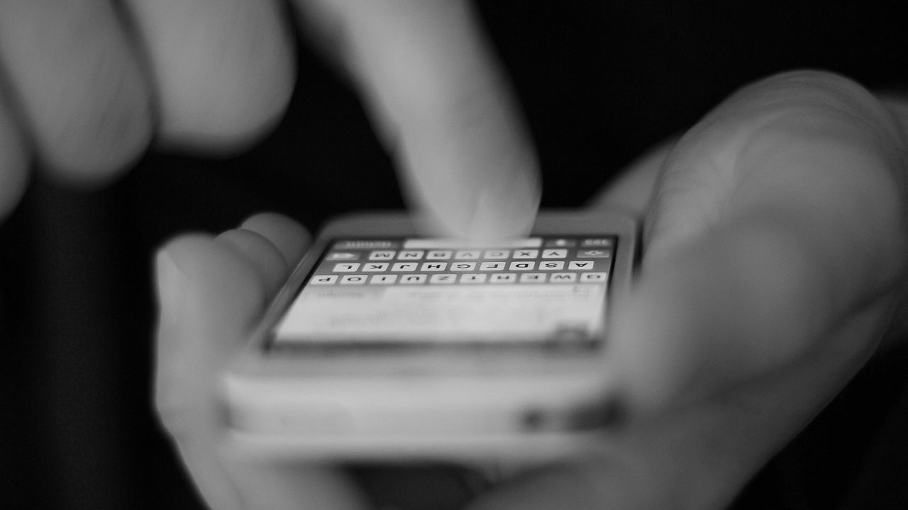 A close-up of a smartphone screen displaying app icons on a gradient background.