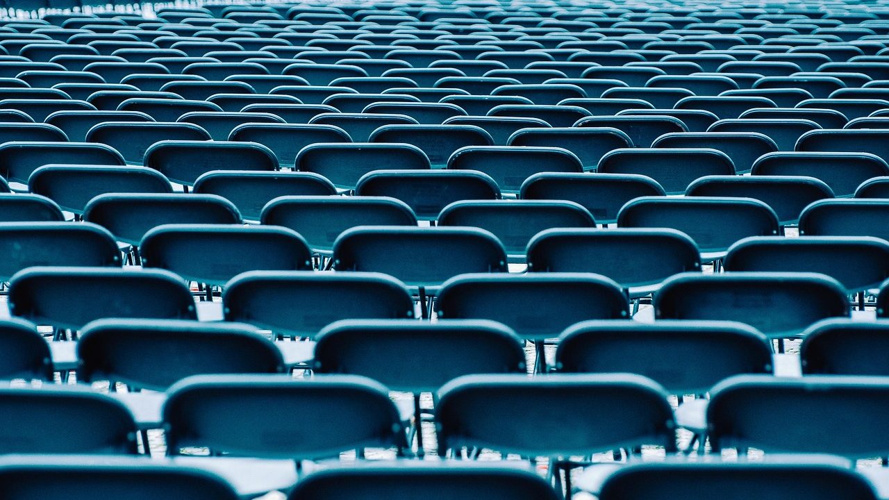 The curved rows of delegates' seats inside a large international assembly chamber.