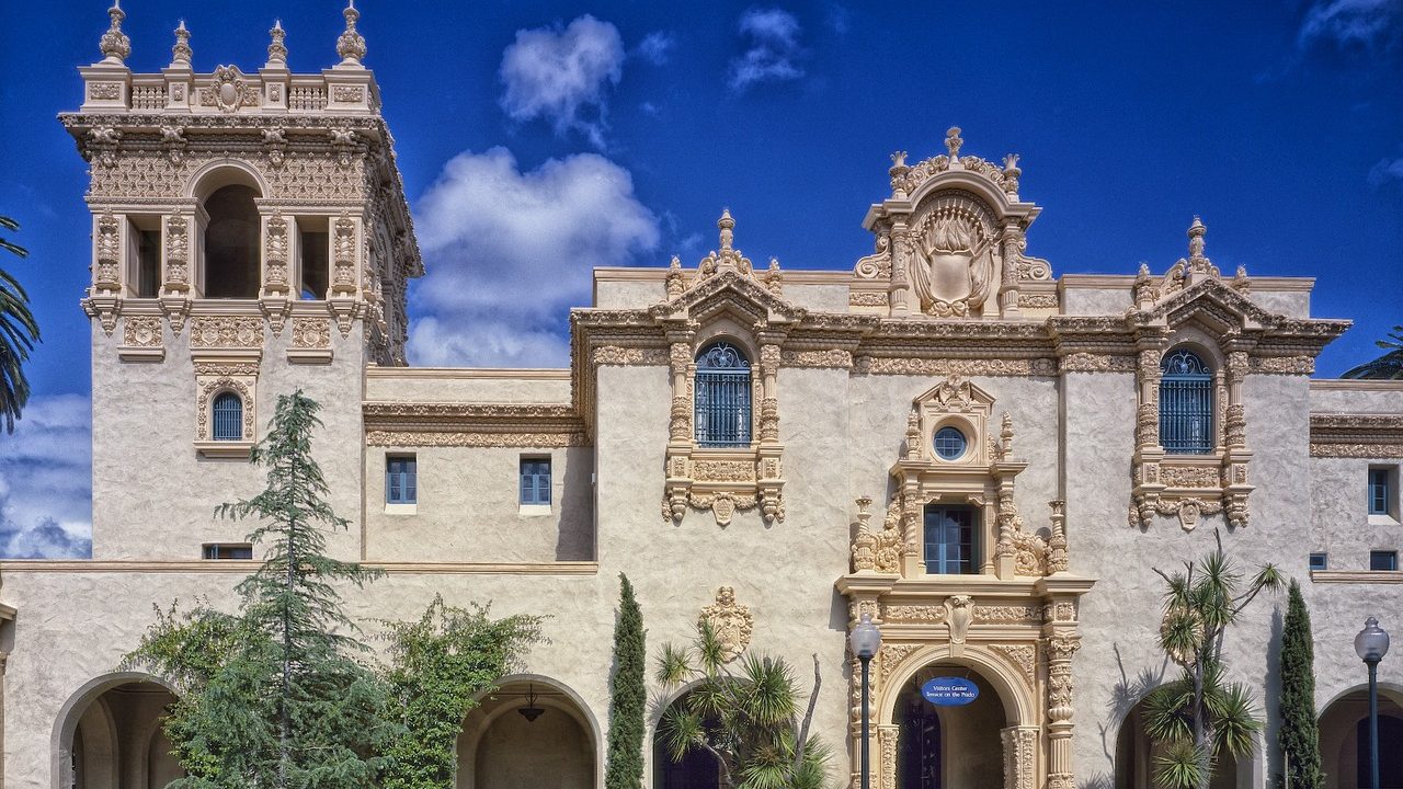 The ornate Spanish Colonial facade of a museum building in Balboa Park on a clear sunny afternoon.
