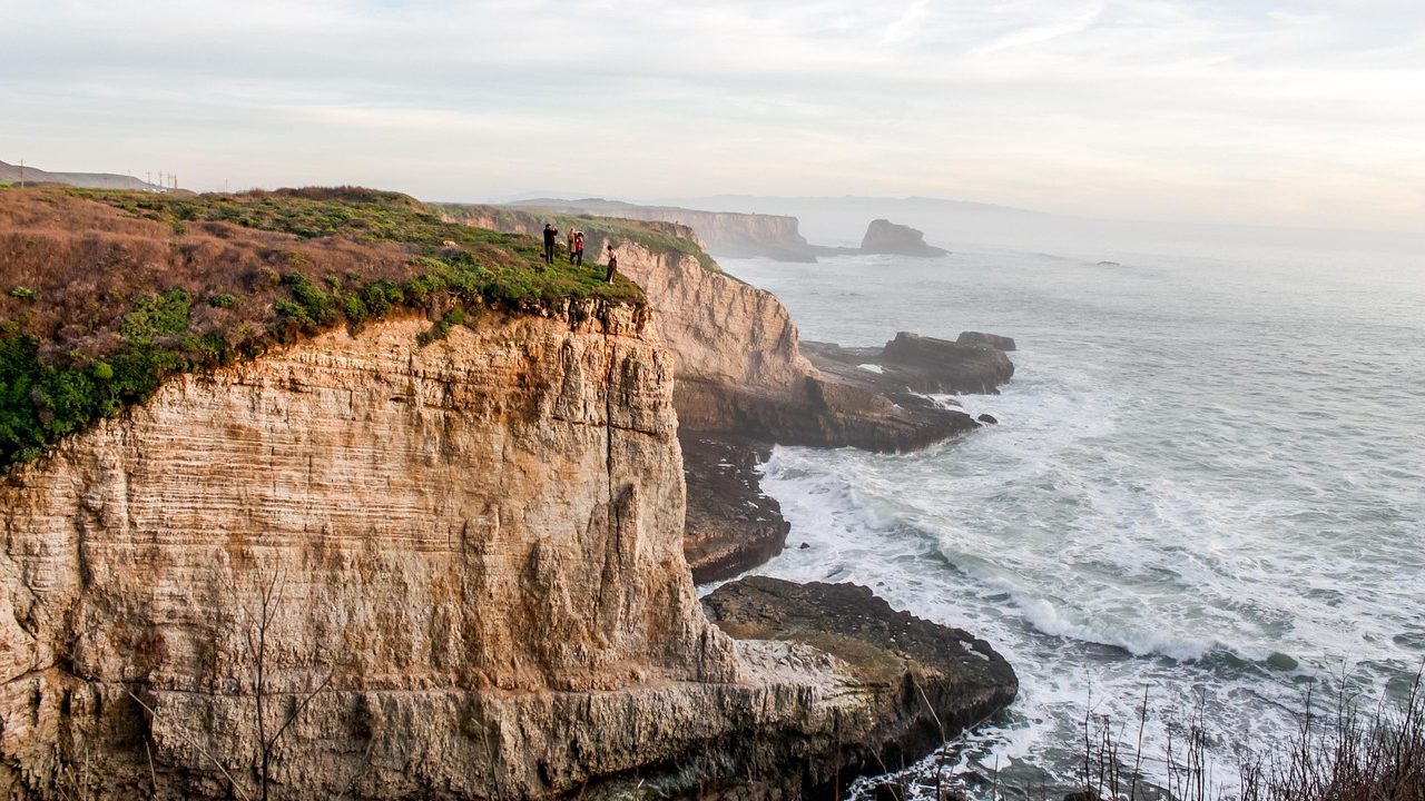 Eroded sandy cliffs along a Southern California beach with the ocean in the background.